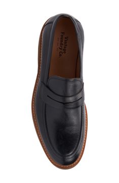 A classic penny keeper distinguishes this leather loafer for a timeless well-dressed staple. Lace-up style Cushioned insole Leather upper/leather and textile lining/rubber soe Imported Vintage Slip-on Loafers For Work, Vintage Oxfords With Leather Footbed For Work, Vintage Leather Oxfords For Work, Vintage Leather Oxford Shoes For Work, Masculine Loafers With Leather Footbed And Round Toe, Classic Black Loafers With Goodyear Welt Construction, Vintage Leather Loafers With Rubber Sole, Retro Leather Sole Loafers For Work, Retro Leather Loafers For Work