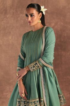 Moss green anarkali edged with kinari and embellished with border. Comes with irisbud foil printed sharara edged with kinari and a printed dupatta.
Components: 3
Pattern: Foil Printed, Embroidered
Type Of Work: Irisbud
Neckline: Round
Sleeve Type: Full
Fabric: Anarkali and Sharara- Raw Silk, Dupatta- Organza
Color: Green
Other Details: 
Disclaimer: The actual print-placement and colour of the product may vary slightly from the image shown.
Occasion: Sangeet - Aza Fashions Short Anarkali Suits, Green Sharara, Printed Sharara, Mom Dresses, Green Anarkali, Sharara Designs, Choli Dress, Happy Dresses, Traditional Attires