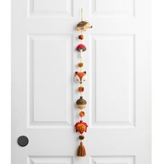 a white door with an assortment of ornaments hanging from it's side and on the front