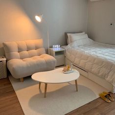 a bedroom with a couch, bed and coffee table