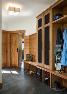 the inside of a house with wood paneling and black tile flooring on the walls