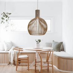 a dining room table with chairs and a bench