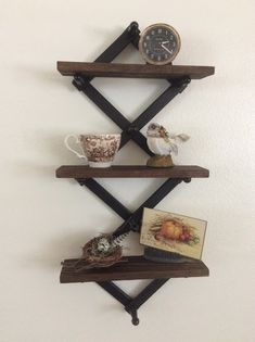 a shelf with some items on it and a clock hanging from the wall behind it