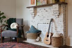 a living room filled with furniture and a fire place in front of a brick wall