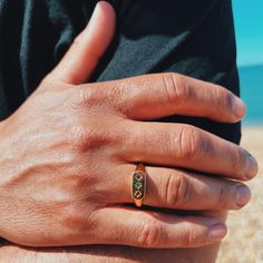 Introducing the Trinity Brilliance Signet Ring, a modern masterpiece crafted from Sterling Silver 925 Gold Vermeil adorned with three natural gemstones--Emerald, Amethyst, and Garnet. This ring isn't just jewellery; it's a celebration of unity, balance, and harmony symbolized by the triad of exquisite gemstones. Each gemstone brings its own unique energy to the ring: Emerald: Known for love, abundance, and harmony, Emerald opens the heart chakra, fostering emotional healing and nurturing qualities. It enhances intuition and brings clarity to thoughts, attracting prosperity and growth. Amethyst: Revered as a stone of spiritual protection and purification, Amethyst connects with the third eye and crown chakras, heightening spiritual awareness, intuition, and consciousness. It promotes medita Modern Multi-stone Emerald Ring Gift, Elegant Adjustable Gemstone Signet Ring, Adjustable Gemstone Signet Ring, Amethyst Gemstone Signet Ring For Gifts, Yellow Gold Garnet Signet Ring With Gemstone, Red Gemstone Signet Ring For Gift, Amethyst And Garnet, Garnet And Gold, The Trinity