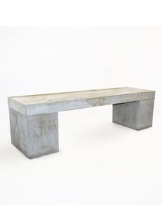 a concrete bench sitting on top of a white floor