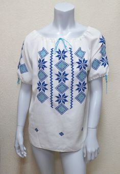 Wonderful 1970s vintage embroidered Mexican peasant blouse. Blouse is made of a fabric that feels like a cotton blend. It features dark and light blue cutwork and embroidery on a white background. Drawstring neck and sleeves. Fabric has some slubs and imperfections in the weave. There is one spot in back that looks like a repair. Otherwise in excellent vintage condition.Measurements:Bust 42", Waist 42", Length 25"****************************************************Please be sure to check out our Vintage Blue Embroidered Blouse, White Cotton Peasant Embroidered Top, Blue Cotton Peasant Top With Floral Embroidery, Folk Style Cotton Blouse With Machine Embroidery, Cotton Folk Blouse With Machine Embroidery, Folk Style Blue Peasant Top With Floral Embroidery, Blue Embroidered Folk Peasant Top, Folk Style Embroidered Cotton Top With Motif, Blue Cotton Folk Peasant Top