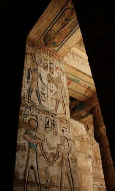 an ancient wall with egyptian paintings on it