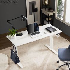 a white desk with two laptops on it