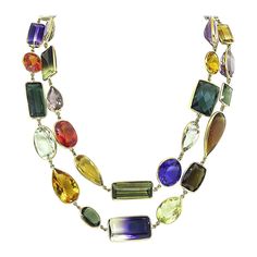 This is a wonderful 14k yellow gold multi color semi precious stones necklace. The necklace features oval, pear, emerald, round, trapezoid, marquise and cushion cut of amethyst, citrine, green tourmaline, blue topaz and quartz. The approximate weight of this lovely stones is a total of 550.00ct. The necklace measures 19mm in width at the widest base and 39 1/4 inches in length. The necklace weighs 125 grams. Luxury Multi-stone Jewelry For Celebration, Luxury Multicolor Amulet Necklace, Stones Necklace, Unusual Jewelry, Semi Precious Stones, Green Tourmaline, Link Necklace, Semi Precious Gemstones, Stone Necklace