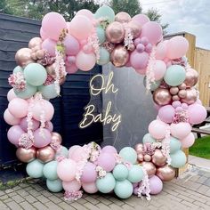 a wreath made out of balloons and streamers with the words oh baby on it