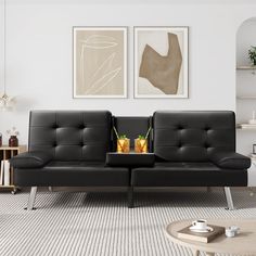 a living room with two black leather couches