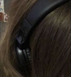 the headphones are on top of someone's hair