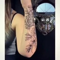 a woman with a flower tattoo on her arm