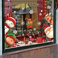 a store window with christmas decorations and snowmen