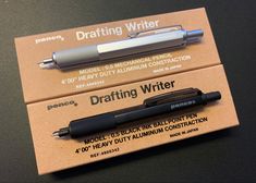 two pens sitting next to each other on top of a card that says drafting writer