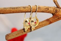 "Exquisite, antique-style very small ruby and 14k, 18k or 22k solid gold hook earrings, in an ethnic indian boho style. These amazing drop earrings have a decorated domed disc and a tiny ruby set in the middle of it. At the bottom of the disc on each earring, there are three gold dots that add character to these boho earrings. These earrings are elaborate and delicate but still very noticeable. They have a unique eye-catching boho look that will go with and upgrade any outfit. Get them as a beau Ruby Earrings Gold, Gold Earrings Bridal, Ruby Set, Gold Bridal Earrings, Solid Gold Earrings, Ruby Earrings, Gold Dots, Recycled Gold, Hook Earrings