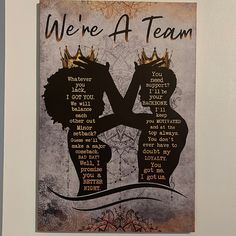 there is a poster on the wall that says we're a team with two women holding each other