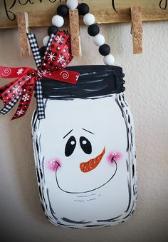 a painted mason jar hanging on a wall