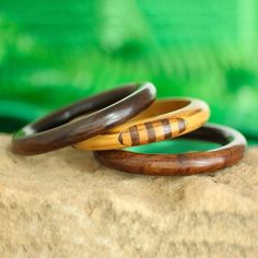 For a chic addition to your wardrobe, this set of three bangle bracelets is presented by Vipin in India. He works with local artisans, who hand-carve each bangle from mango wood. Two bracelets feature a solid hue in dark brown while the third displays a light brown hue with striped patterns. This set is perfect for wearing together or sharing with friends. Yard Sale Finds, India Jewelry, Jewelry Packaging, Mango Wood, Jewelry Gift Box, Bracelet Sizes, Light Brown, Diamond Jewelry, Leather Bracelet