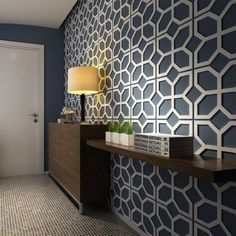 a room with blue and white wallpaper on the walls next to a wooden shelf