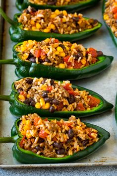 green peppers stuffed with rice and beans on a baking sheet