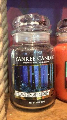 yankee candles are sitting on a shelf in a store