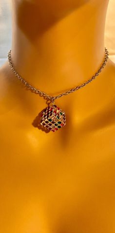 This " Rainbow cube" necklace is handmade. The necklace is made out of a metal cube with multicolored rime stones. We usually ship packages within 1-2 business days and you will receive an email notification when we ship your package. Depending on your location, our shipping time takes about 4-5 business days. Thank you for your support and have a wonderful day! :3 HAVE QUESTIONS? Please don't hesitate to reach out! 😊 Multicolor Clavicle Chain Choker As Gift, Jeweled Choker Necklaces For Gifts, Jeweled Pendant Necklaces For Gifts, Rhinestone Jewel Necklace As A Gift, Rhinestone Jewel Choker Necklace For Gift, Jeweled Metal Necklaces As A Gift, Costume Rhinestone Necklace For Gifts, Costume Jewelry Choker With Jewels As Gift, Rhinestone Choker Necklace For Gift