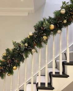 christmas garland on the banisters with pine cones and greenery