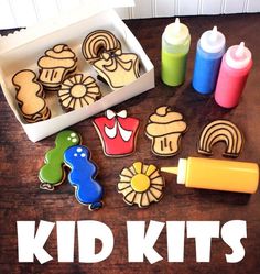 a wooden table topped with lots of cut out cookies