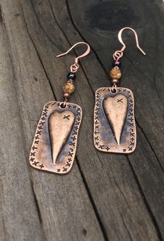 Unique copper heart earrings with Garnet and picture jasper gemstones. You will love these antique copper steam punk heart earrings! Garnet is the stone of love, and it is the perfect complement to the picture jasper stone. These earrings are 2 inches long and 5/8 of an inch wide. They are slightly heavier than most of my other earrings, but not too heavy. Weight is 3.8 grams. The French ear wires are solid copper. All my jewelry comes gift boxed with a custom Shelly Mariposa Design butterfly ca Artisan Heart Earrings For Pierced Ears As Gift, Artisan Heart Earrings As Gift, Handmade Vintage Rust Earrings, Handmade Rust Vintage Earrings, Handmade Vintage Rust-colored Earrings, Vintage Handmade Rust Jewelry, Copper Heart Pendant For Jewelry Making, Soldered Copper Earrings As A Gift, Rustic Drop Earrings Jewelry Gift