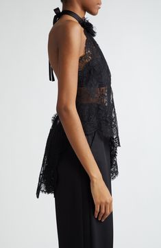 The Italian house's obsession with lace brings dark romance to your collection with a sheer Chantilly top cut with a diagonally slanted, asymmetric hem. A back-baring halter neck centered with a voluminous rosette appliqué brings drama to your look, while a cascading bow at the nape adds a coquettish touch. Adjustable back tie closure Halter neck Sheer; base layer shown not included 68% cotton, 22% nylon, 10% silk Dry clean Made in Italy Designer Clothing Elegant Delicate Lace Top For Night Out, Elegant Scalloped Lace Tops For Party, Luxury Sheer Tops For Evening, Elegant Party Lace Top With Delicate Lace, Elegant Party Lace Top With Delicate Detail, Elegant Evening Lace Top, Elegant Delicate Lace Top For Party, Sheer Sleeveless Lace Top For Evening, Luxury Sheer Tops For Party