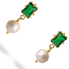 Minimalist Emerald & Pearl Statement Earrings, crafted in 18k gold plating. These chic earrings feature a regal emerald stone set in a sleek gold frame, with a delicate pearl dangling below. The combination of the vibrant emerald and classic pearl creates a sophisticated yet minimalist design, perfect for adding a touch of refinement to any look. Ideal for both formal occasions and elevating everyday style, these earrings are the epitome of understated luxury. Details 18k gold plated on brass Emerald and Pearl Avoid contact with chemicals, makeup, parfume. Do not use dips or abrasive cleaners on earrings. To clean and brighten it up your earrings, wipe them gently with jewelry polishing cloth. Pearl Statement Earrings, Luxury Details, Emerald Green Earrings, Understated Luxury, Chic Earrings, Forever Jewelry, Jewelry Ring Box, Men's Jewelry Rings, Emerald Stone