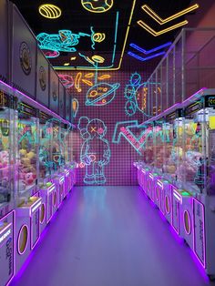 a room filled with lots of vending machines covered in neon lights and cartoon characters