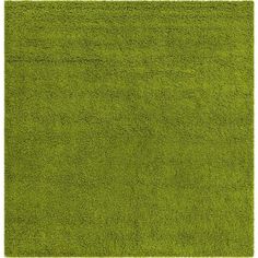 an area rug with green grass in the middle