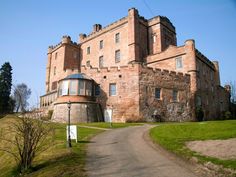 an old castle with a road leading to it