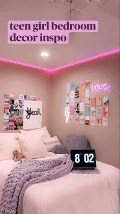 a bedroom with pink lights and white bedding