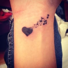 a black heart with musical notes on it's side wrist tattoo designs for women