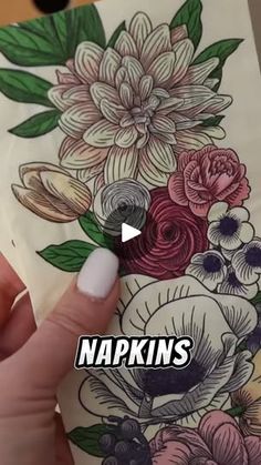 someone is painting flowers on a piece of paper