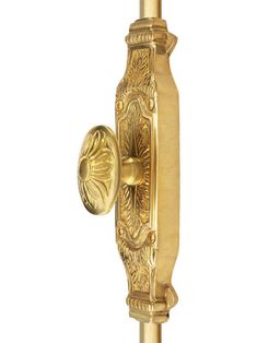 an antique brass door handle with ornate carvings on the front and sides, set against a white background