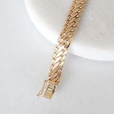 This stunning vintage bracelet crafted in 14k yellow gold and is perfect to wear on its own or layered with other bracelets! Metal: Genuine 14k yellow gold Closure: Box with clip Width: 7.8 mm Length: 7.5 inches Weight: 8.1 grams Please allow up to 5 business days for processing. Currently only shipping within Canada and the USA.  | c u r a t e d | Visit our website for curated and modern pieces  https://www.menkduke.com | f a c e b o o k | Follow us on Facebook for new item announcements and di Antique Gold Bracelets For Anniversary, Antique Gold Bracelet Strap Jewelry, Timeless Gold Bracelet With Curb Chain For Formal Occasions, Formal Gold Cuban Link Bracelet With Polished Finish, Timeless Formal Bracelet With Curb Chain, Timeless Curb Chain Bracelet For Formal Occasions, Timeless Formal Curb Chain Bracelets, Gold Curb Chain Bracelets For Formal Occasions, Gold Classic Diamond Bracelet For Formal Occasions