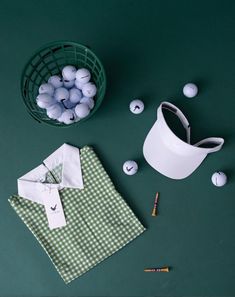 a green table topped with white and black items