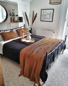 a bedroom with a bed, mirror and other items on the table in front of it