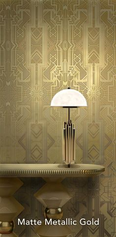 a lamp sitting on top of a table next to a wallpapered wall with geometric designs