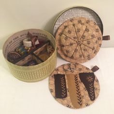 three decorative items are sitting next to each other on a white counter top in front of a box