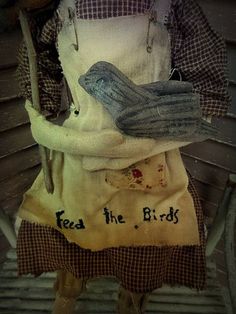 an old fashioned doll holding a bird on its arm with the words fez the bird written on it