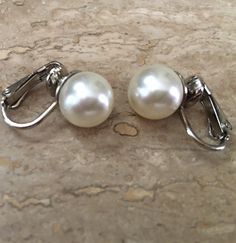 These Classic Pearl Clip on Earrings are so elegant on! I make these using 10mm Swarovski Pearls in your choice of either Cream Ivory or White pearls with finishes in Gold or Silver tone clip settings. Available in some other color choices...just ask! Choose the color and finish from the Drop-down menu. Perfect Bridal Wedding jewelry with clip on backs. These are also available in Pierced styles and quantities for Bridesmaids! These photos show: Silver with Cream Ivory pearls and Gold with White Classic Clip-on Earrings For Wedding, Classic White Gold Clip-on Earrings For Formal Occasions, Classic White Gold Clip-on Earrings, Classic Clip-on Pearl Drop Earrings, Elegant Round Clip-on Earrings For Wedding, Classic Wedding Clip-on Earrings, White Formal Clip-on Earrings, White Matching Clip-on Earrings For Formal Occasions, Classic White Gold Clip-on Earrings For Anniversary