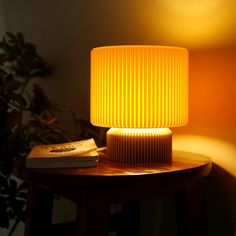 a yellow lamp sitting on top of a wooden table