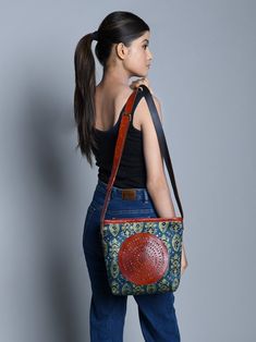 With a captivating blend of tradition and modernity, our Ajrakh Leather Tote Bag is surely a head-turner. Authentic Ajrakh motifs adorn silk fabric, framed by durable leather borders, creating an ethnic masterpiece. The circular brown leather patchwork on the front adds a unique touch. With adjustable leather handles, it transforms effortlessly from a crossbody to a shoulder bag, ensuring versatility in style. The spacious central compartment accommodates books, journals, and even laptops, makin Traditional Brown Leather Shoulder Bag, Traditional Shoulder Bag With Leather Lining, Traditional Brown Bag With Leather Lining, Traditional Leather Tote Shoulder Bag, Traditional Brown Shoulder Bag For Everyday Use, Traditional Leather Shoulder Bag For Everyday, Traditional Bags With Leather Lining For Everyday Use, Traditional Bag With Leather Lining For Everyday Use, Traditional Brown Bags For Daily Use