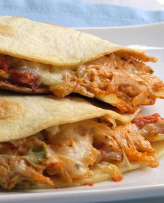 two quesadillas stacked on top of each other with meat and cheese in them